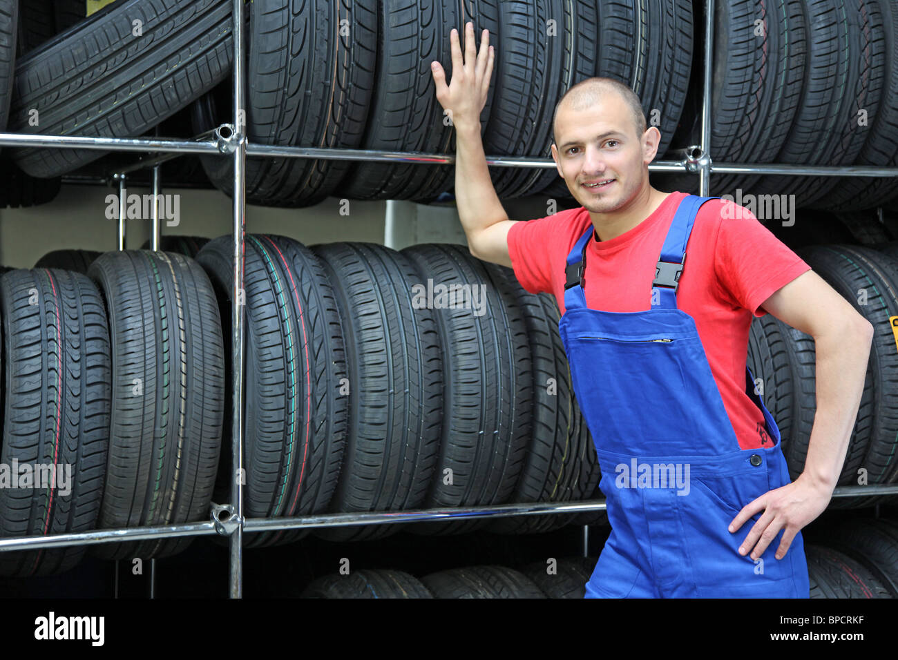 A trustful worker in a tire workshop Stock Photo