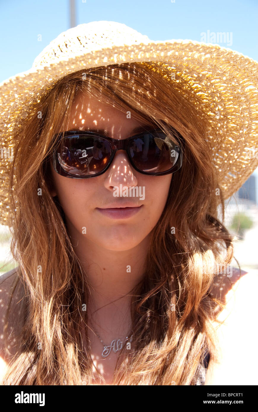 girl in straw hat and sunglasses Stock Photo