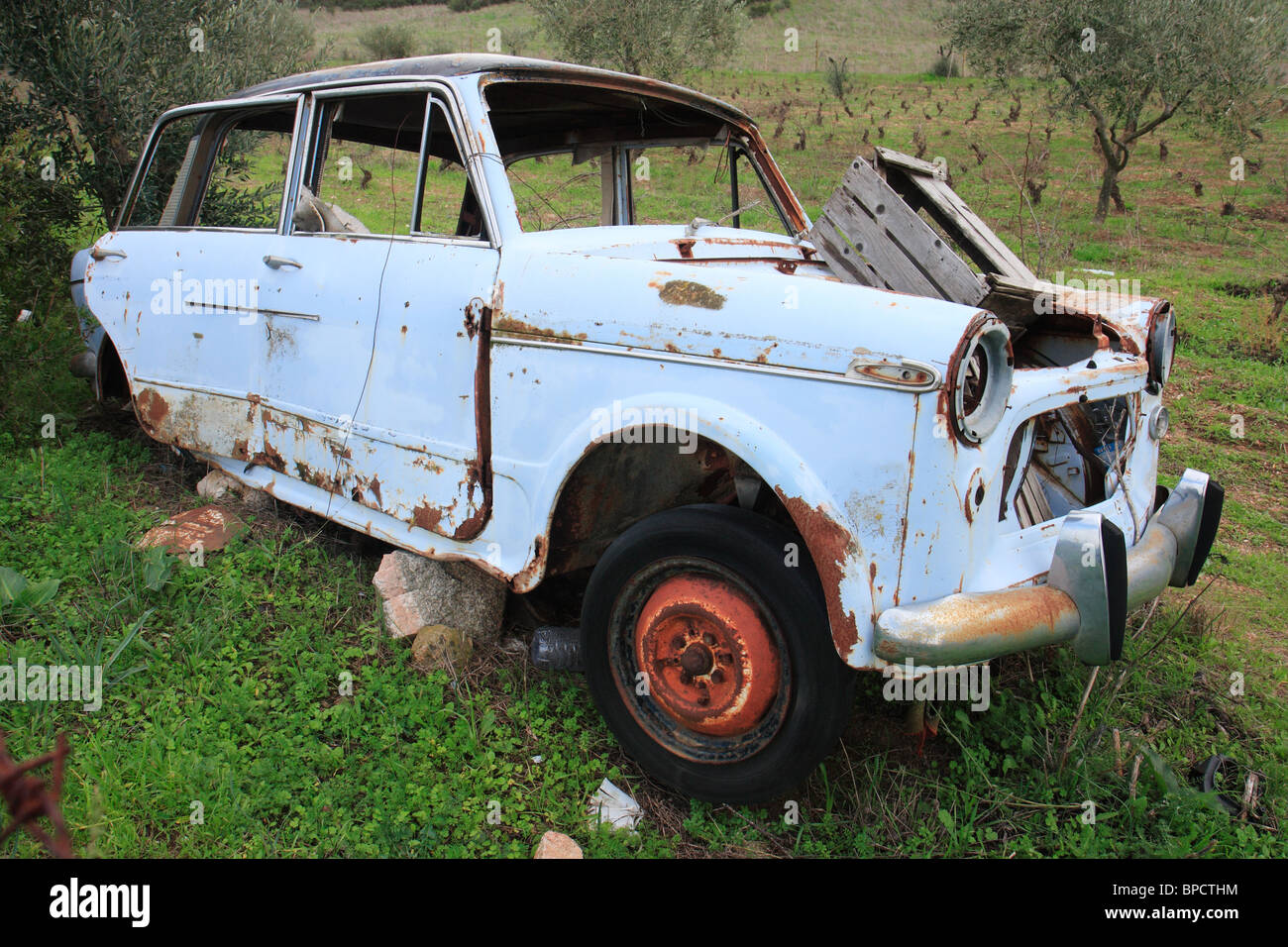 A broken, rusty car on the roadside, Sardinia, Italy Stock Photo