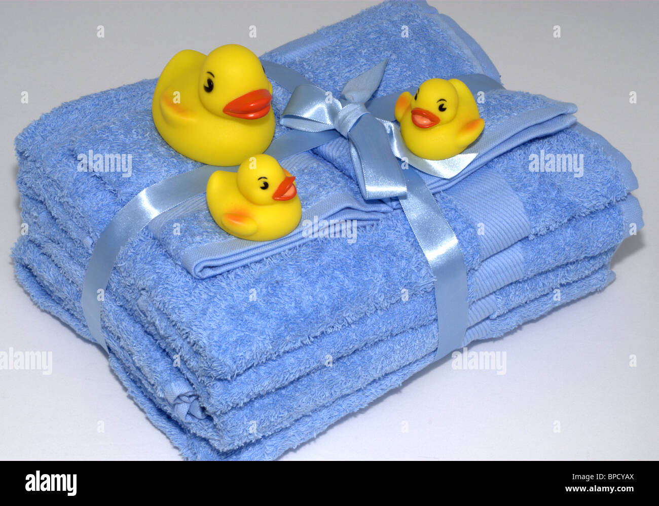 Rubber ducks on blue towels Stock Photo