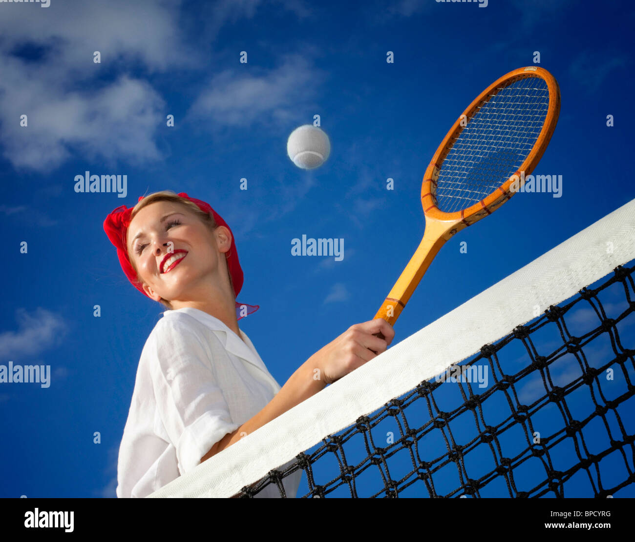 Low angle view of young woman playing tennis Stock Photo
