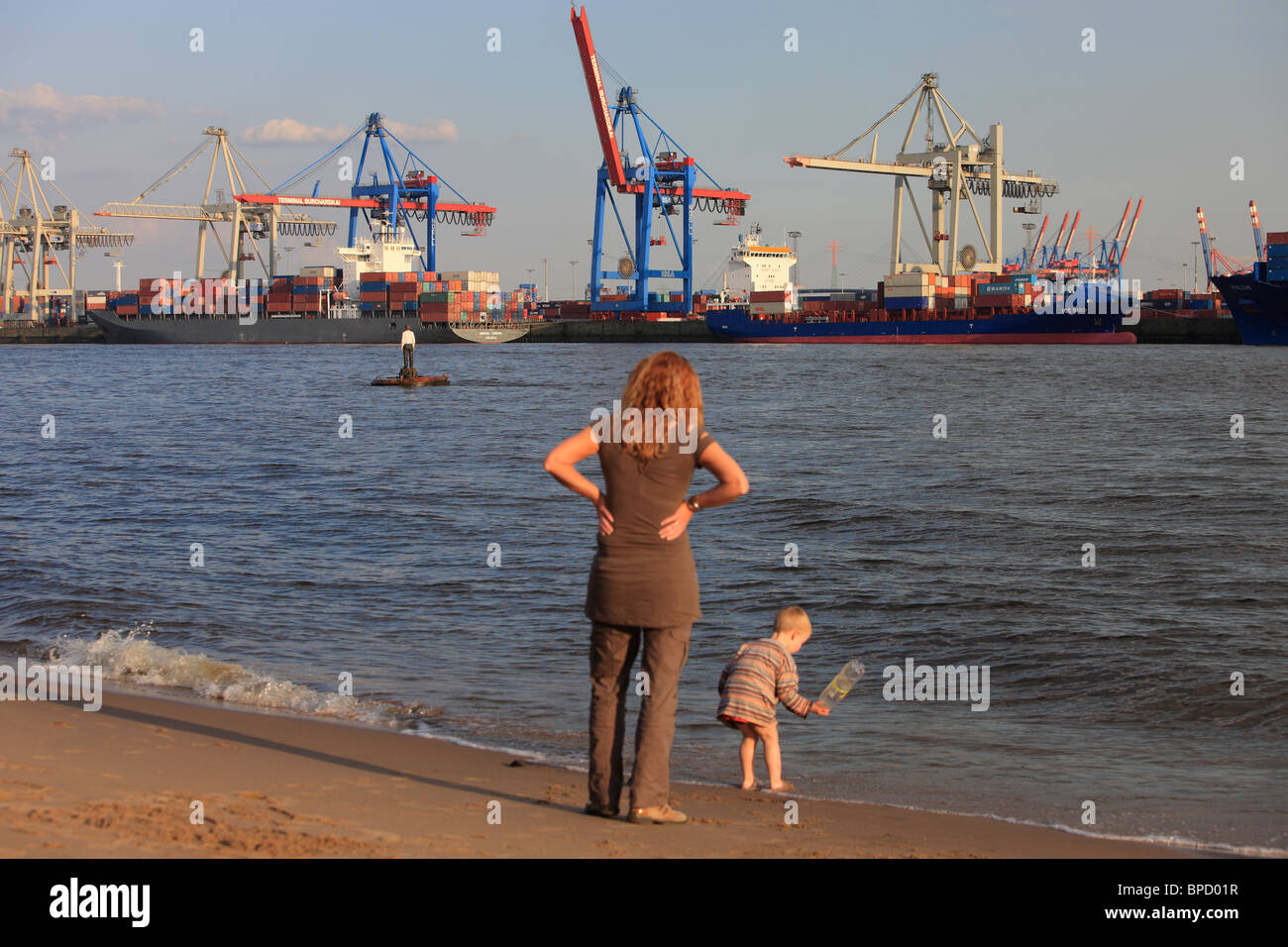 A woman with a child on a beach of the River Elbe, Hamburg, Germany Stock Photo