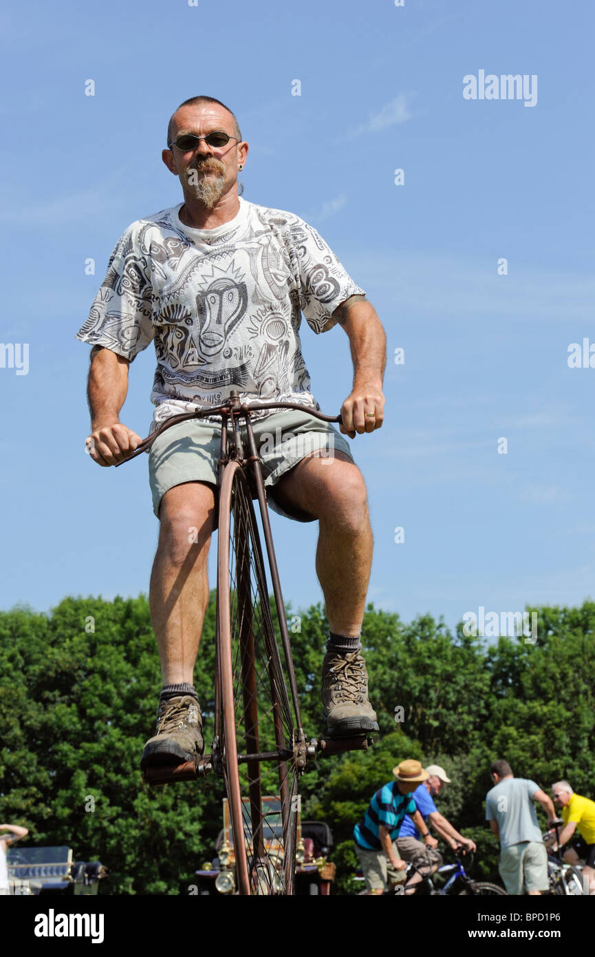 A man riding a penny farthing bicycle Stock Photo