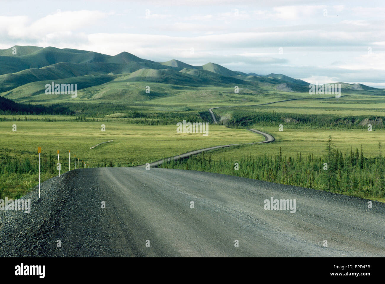 Dempster Highway, Northwest Territories Canada - Long Narrow Winding Gravel Road through Boreal Forest near Richardson Mountains Stock Photo