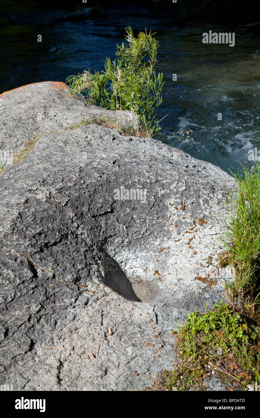 A Native American grinding hole in a boulder streamside, California