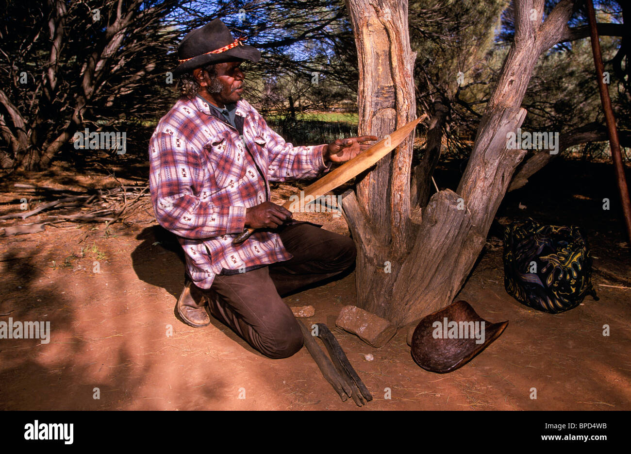 Carving spear thrower, outback Australia Stock Photo