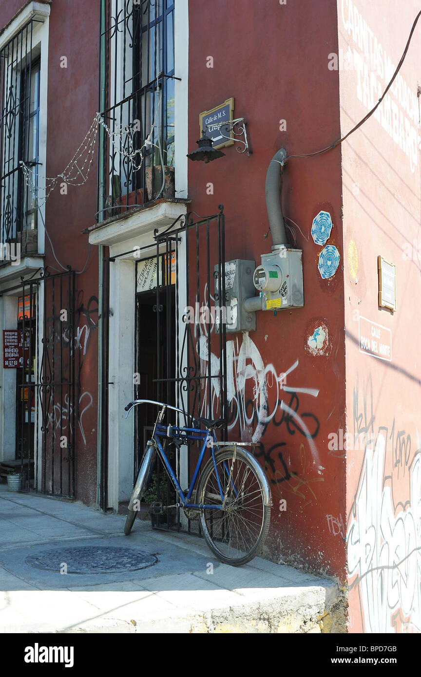 House with graffiti and parked bicycle. Oaxaca, Mexico Stock Photo