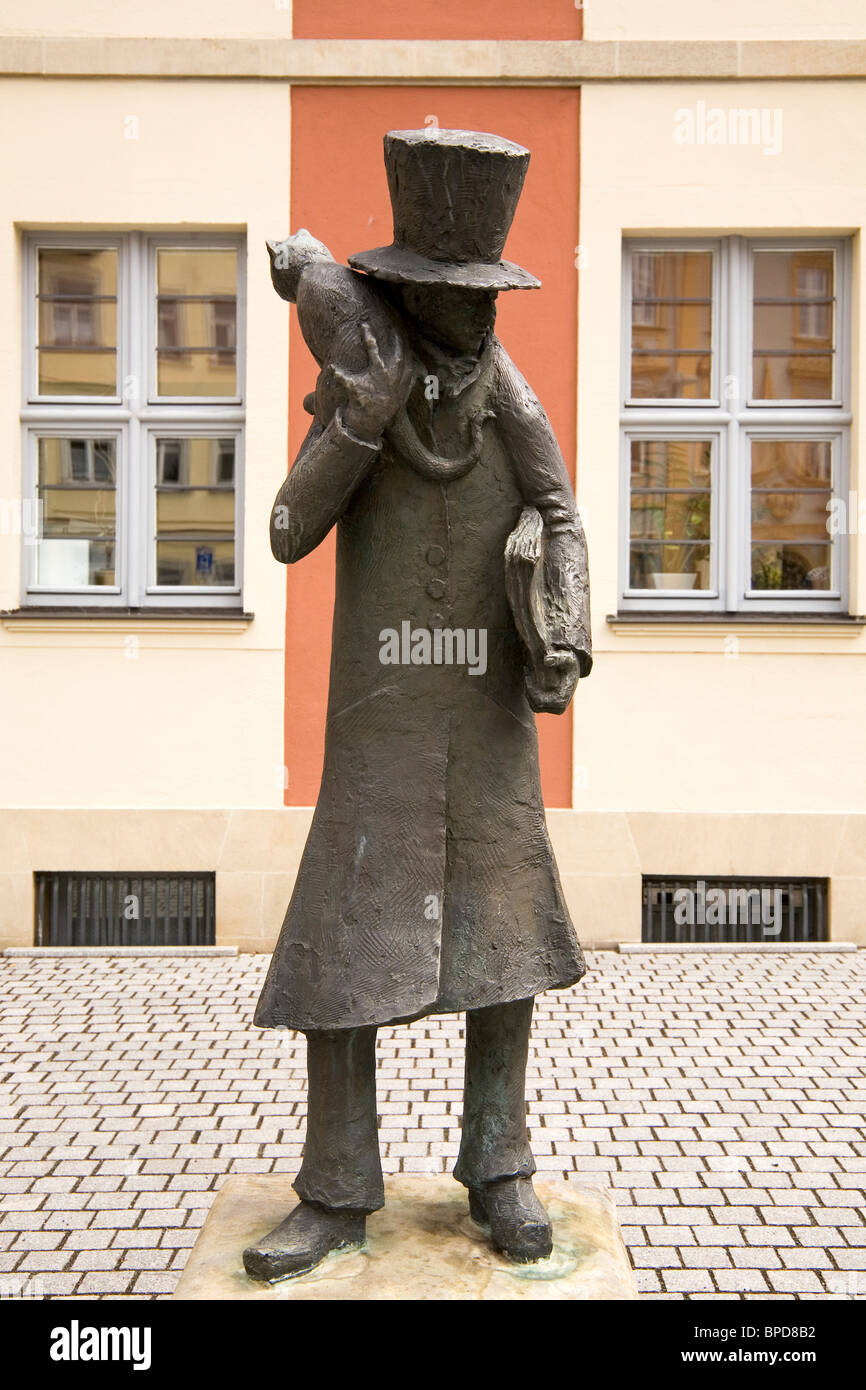Statue of ETA Hoffmann wearing a top hat with a cat and book in Bamberg ...