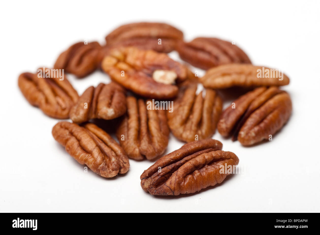 shelled Pecan Nuts (Carya illinoensis) On white Background Stock Photo