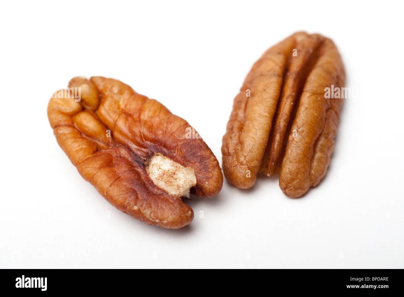 shelled Pecan Nuts (Carya illinoensis) On white Background Stock Photo