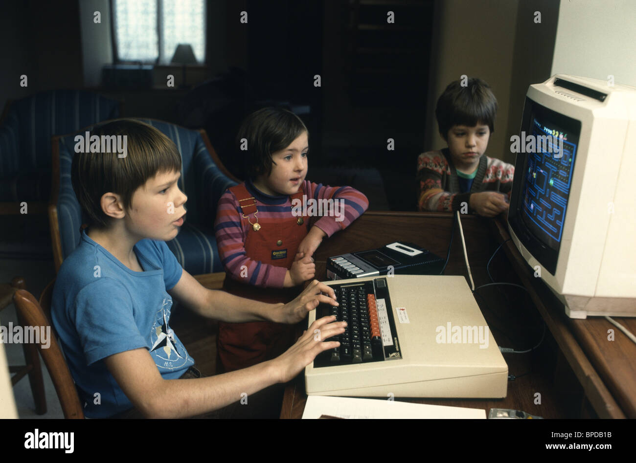 children in the seventies playing on a  computer Stock Photo