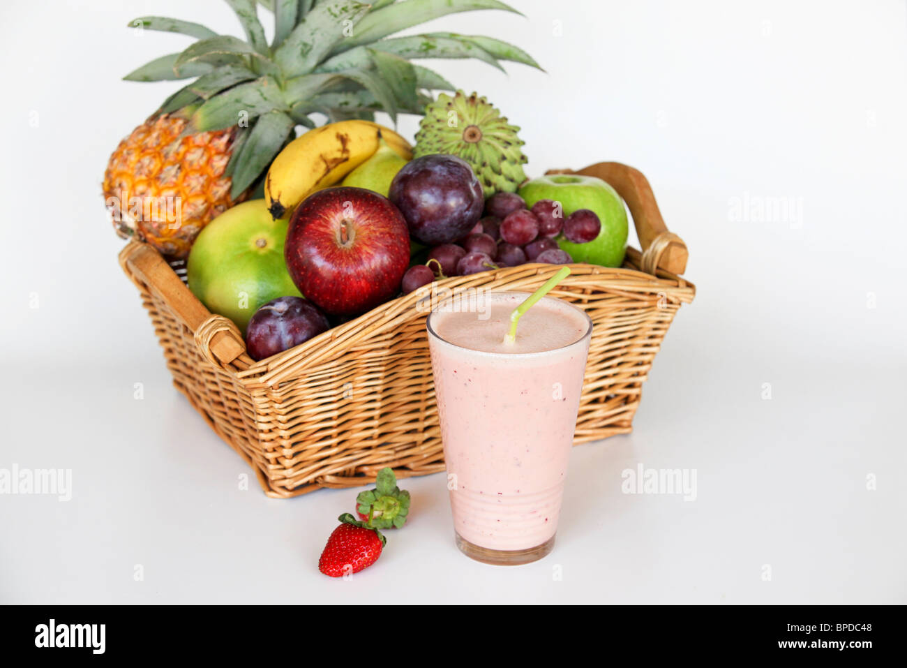 Fruit Health drink with a basket of fresh fruit on white background Stock Photo