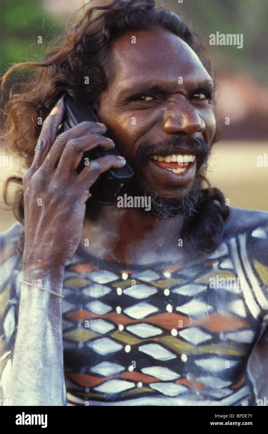 Aboriginal man from Arnhem Land playing part in 'Yolngu Boy' movie on his mobile phone Stock Photo