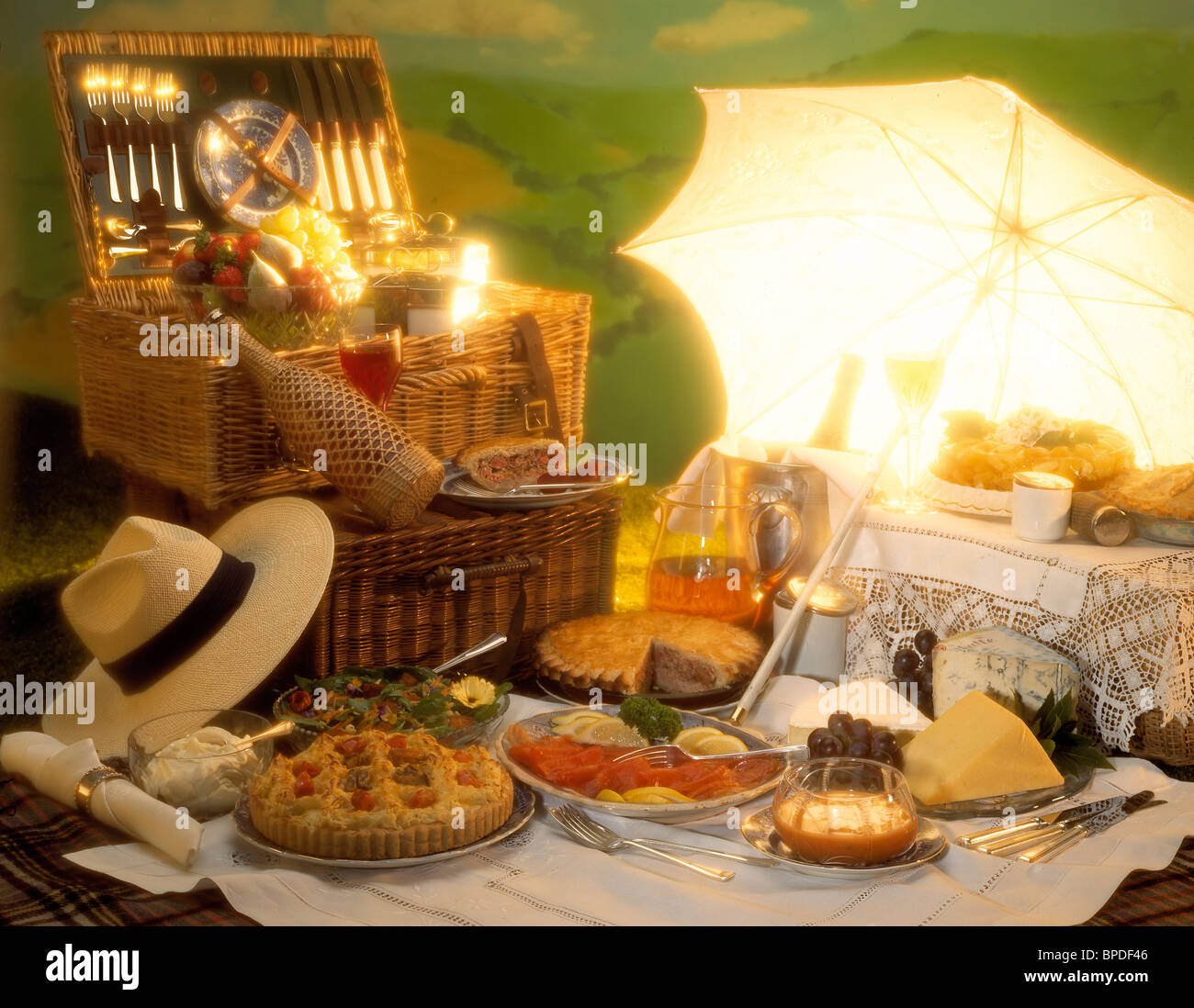 English classic picnic with hamper & food on grass under parasol Stock  Photo - Alamy