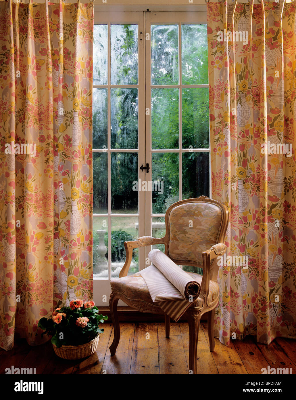 Printed Fabric Curtains On French Doors Leading To Garden With