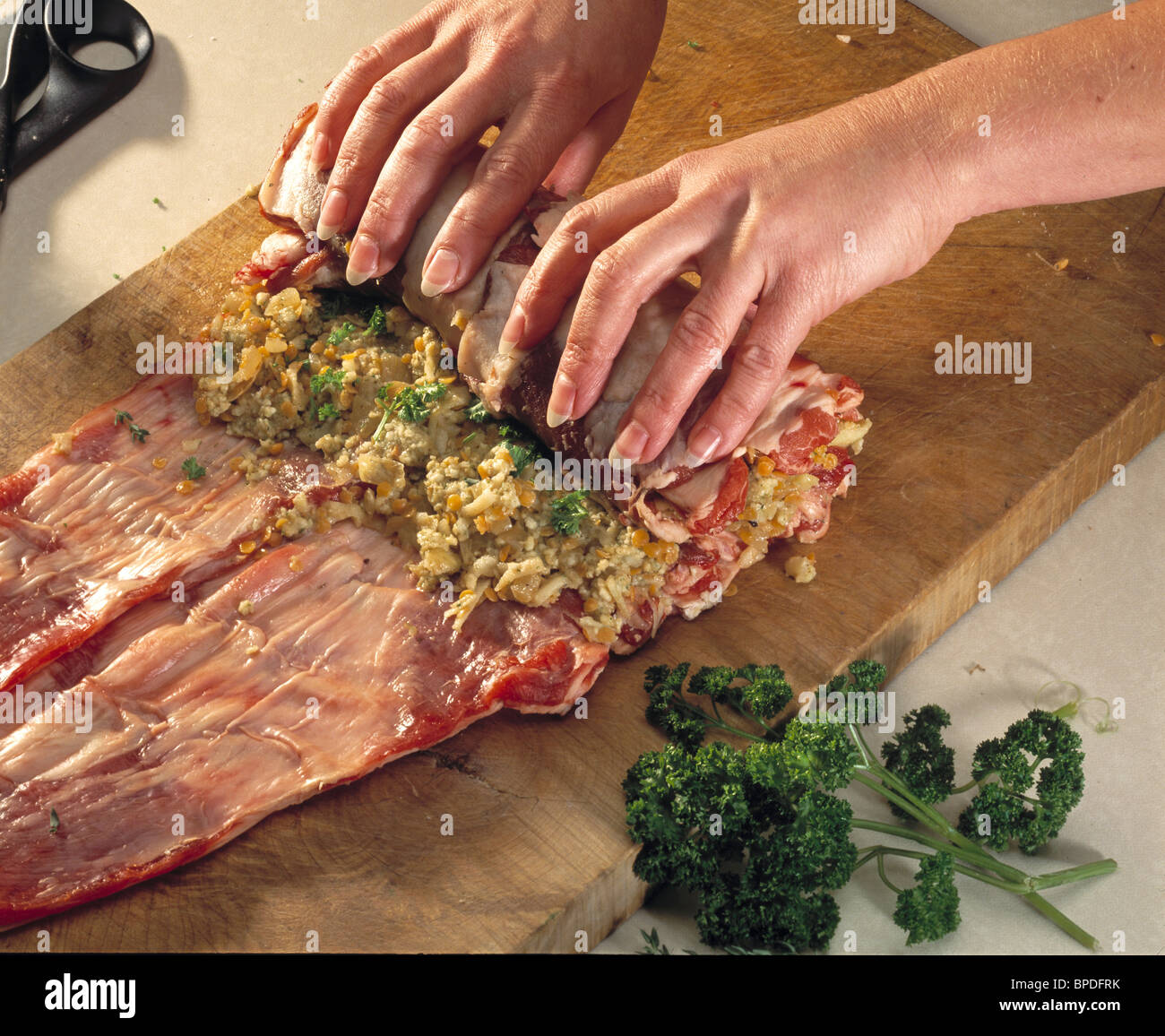 Steps to roast stuffed breast of lamb - rolling the joint with stuffing