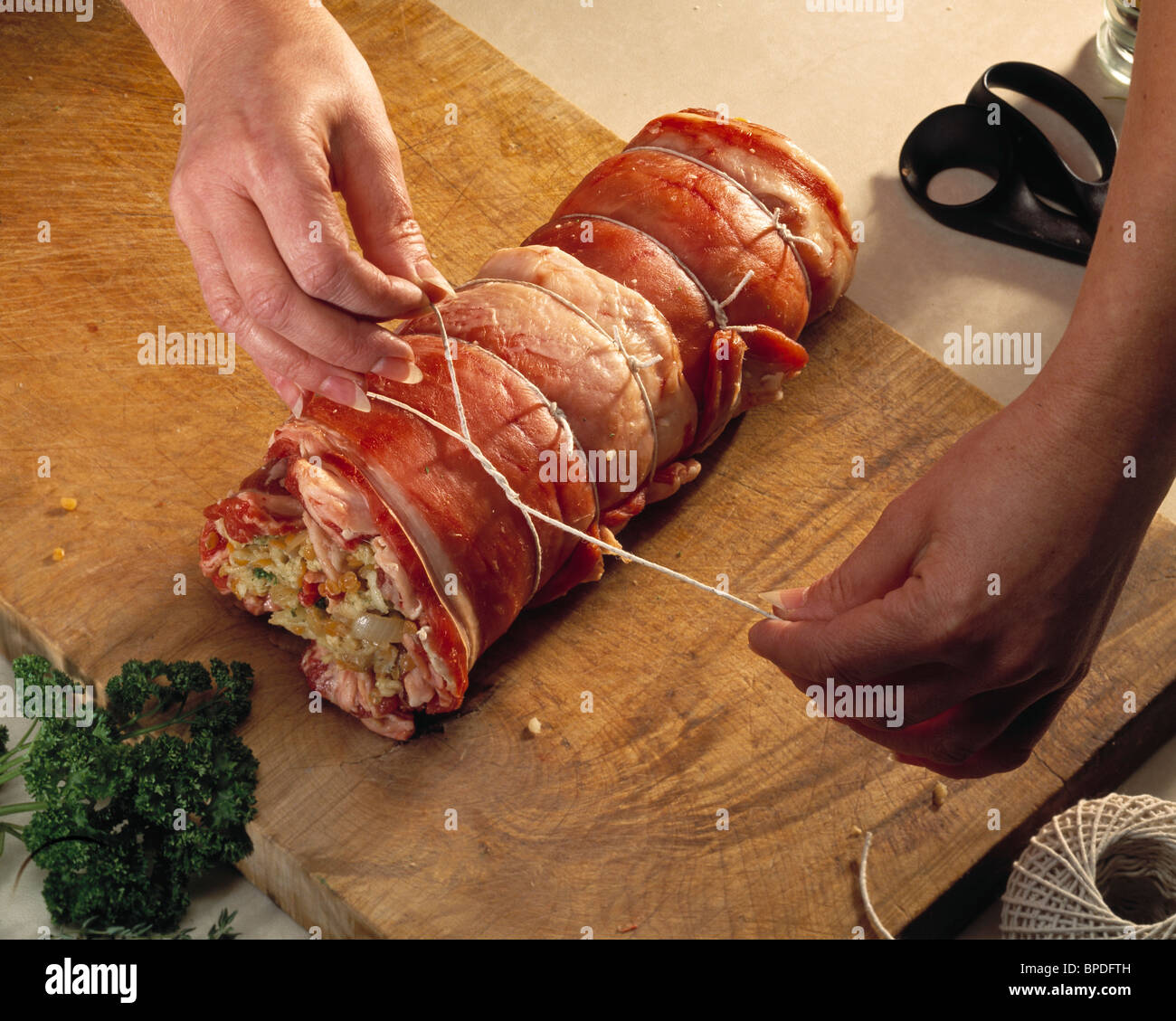 Roast Breast of Lamb stuffed with lentils & herbs - Step 6 tying up the