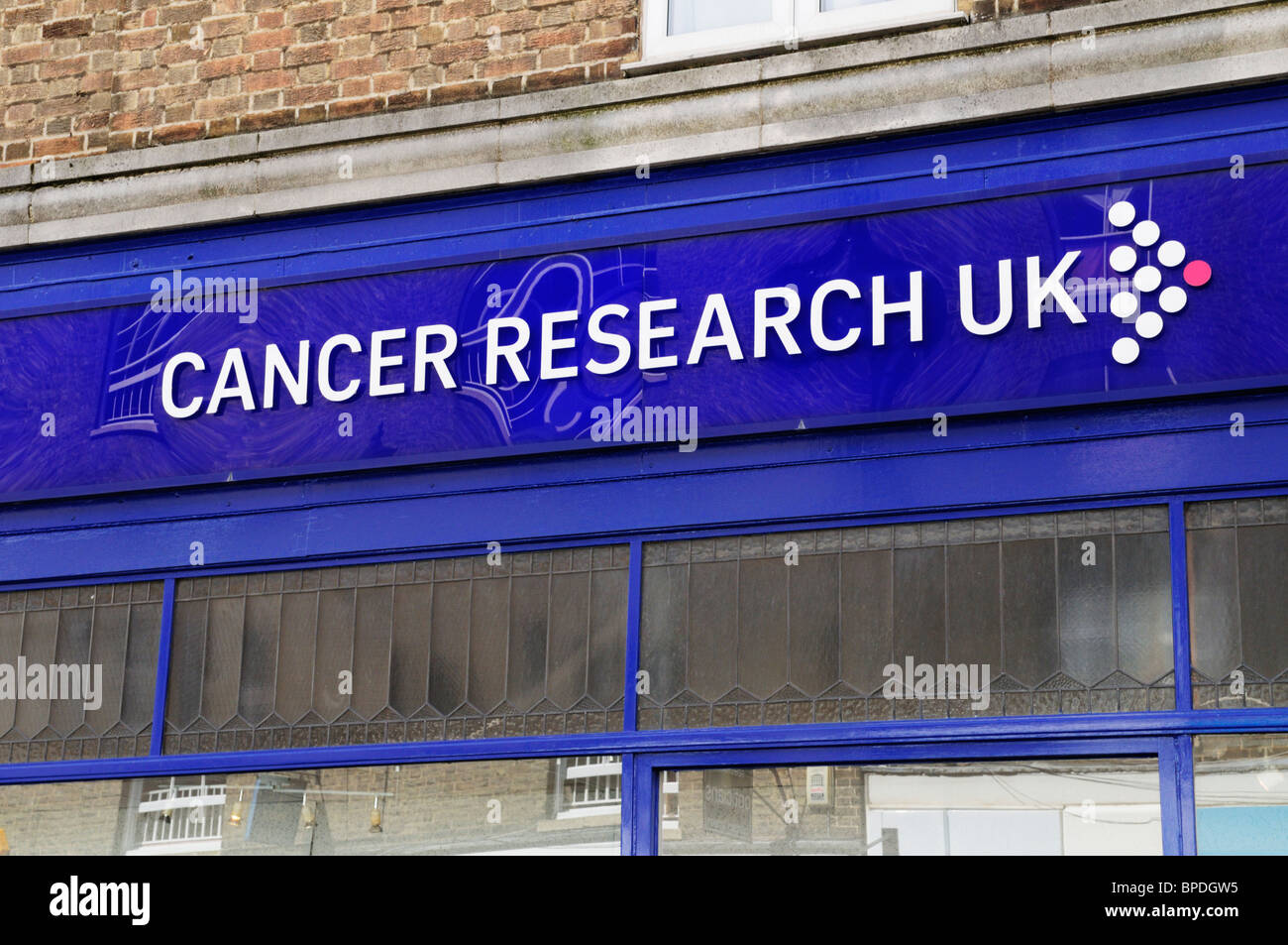 Cancer Research uk charity shop store sign logo, Ely Cambridgeshire, UK Stock Photo