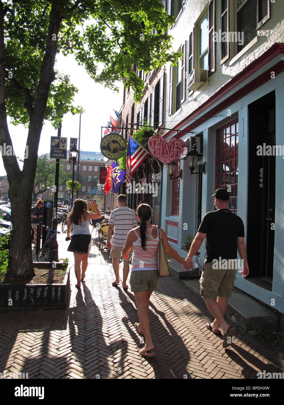 USA, Maryland MD Baltimore Fells Point neighborhood people walking along a sidewalk Stock Photo
