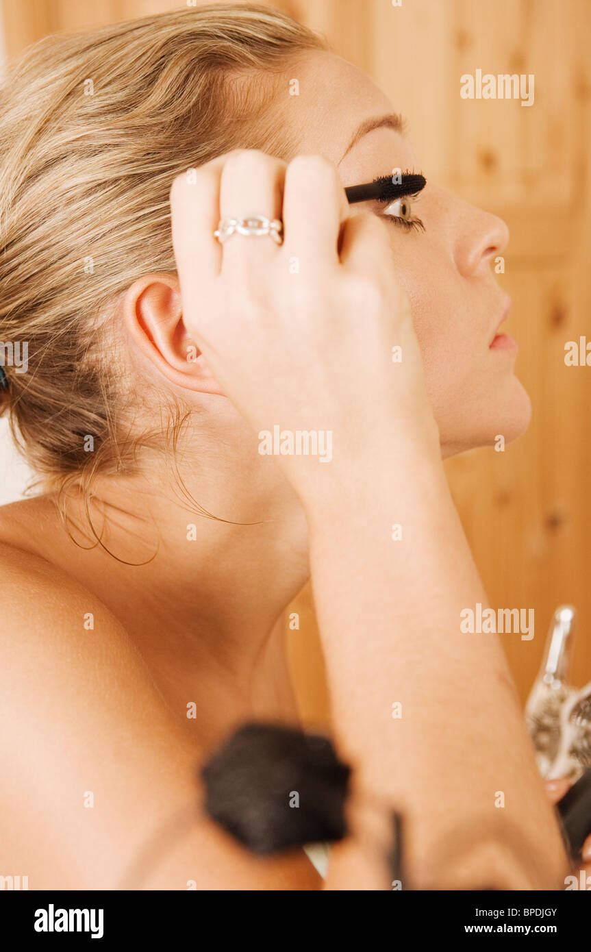 Getting ready for a night out applying makeup. Stock Photo