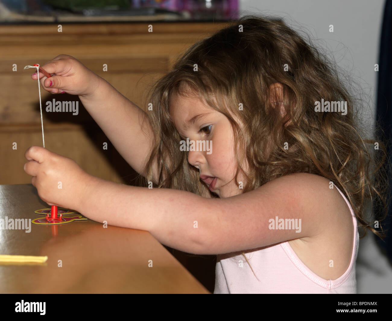 Young Girl Playing Game With Toy Fishing Rod England Stock Photo