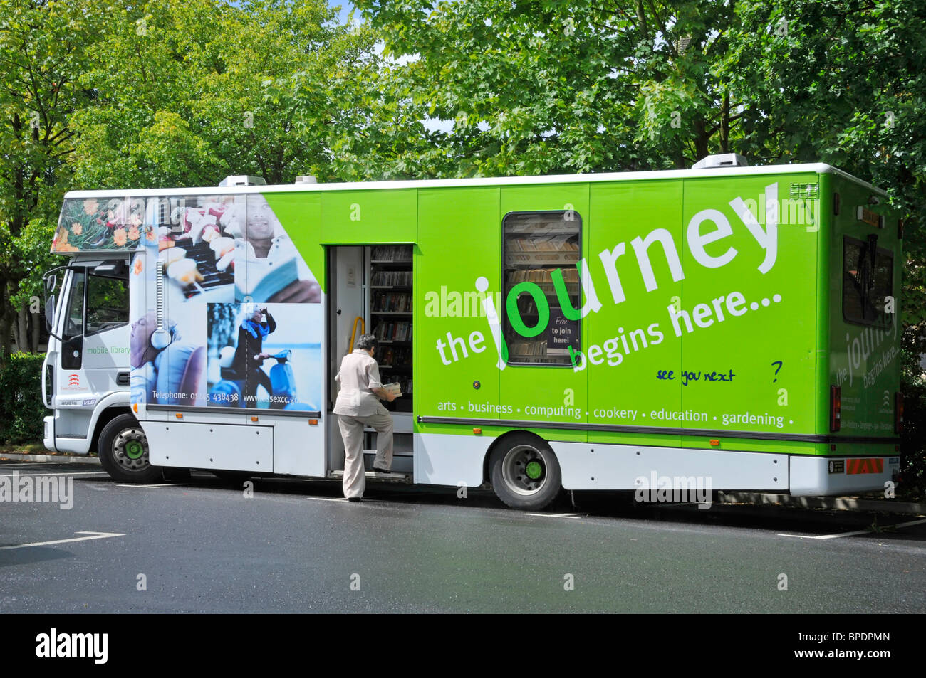 Customer visits Essex County Council mobile book lending library lorry truck van vehicle parked outlying rural village Doddinghurst Essex England UK Stock Photo