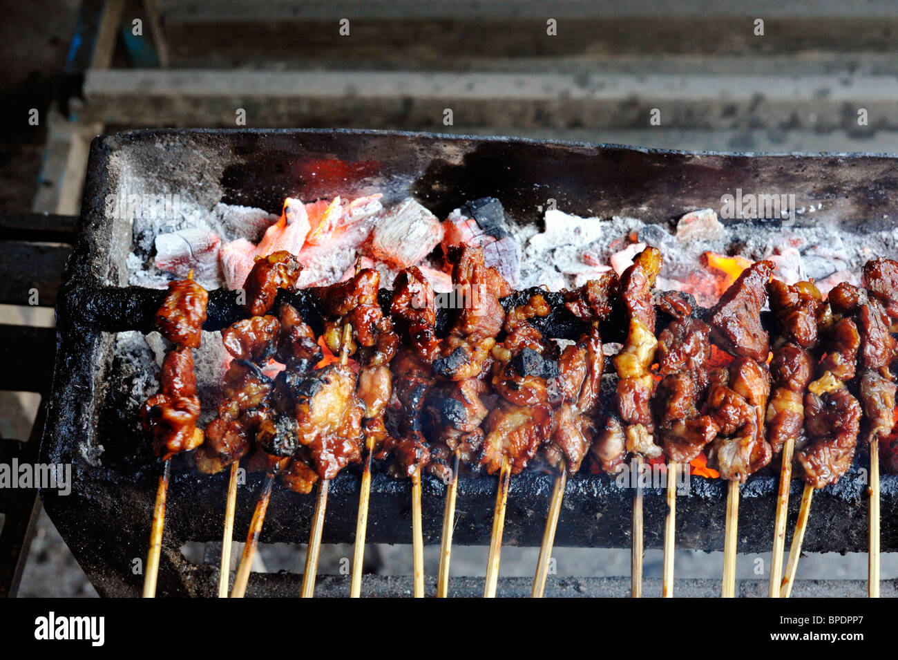 meat sate cooking on charcoal grill in a street in kuta bali Stock Photo -  Alamy