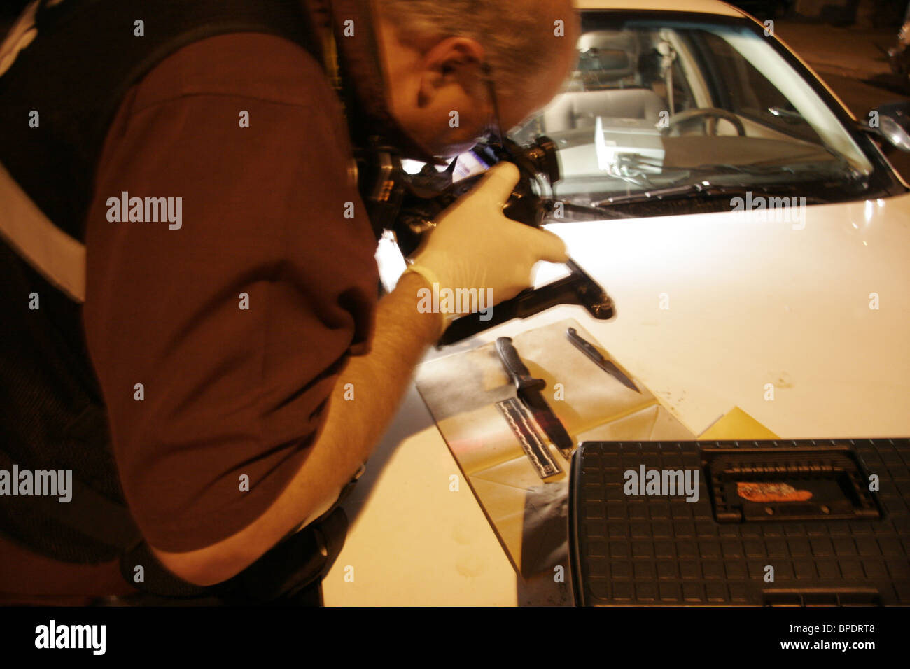 Las Vegas CSI investigator photographs a knife found at the scene of an assault. Stock Photo