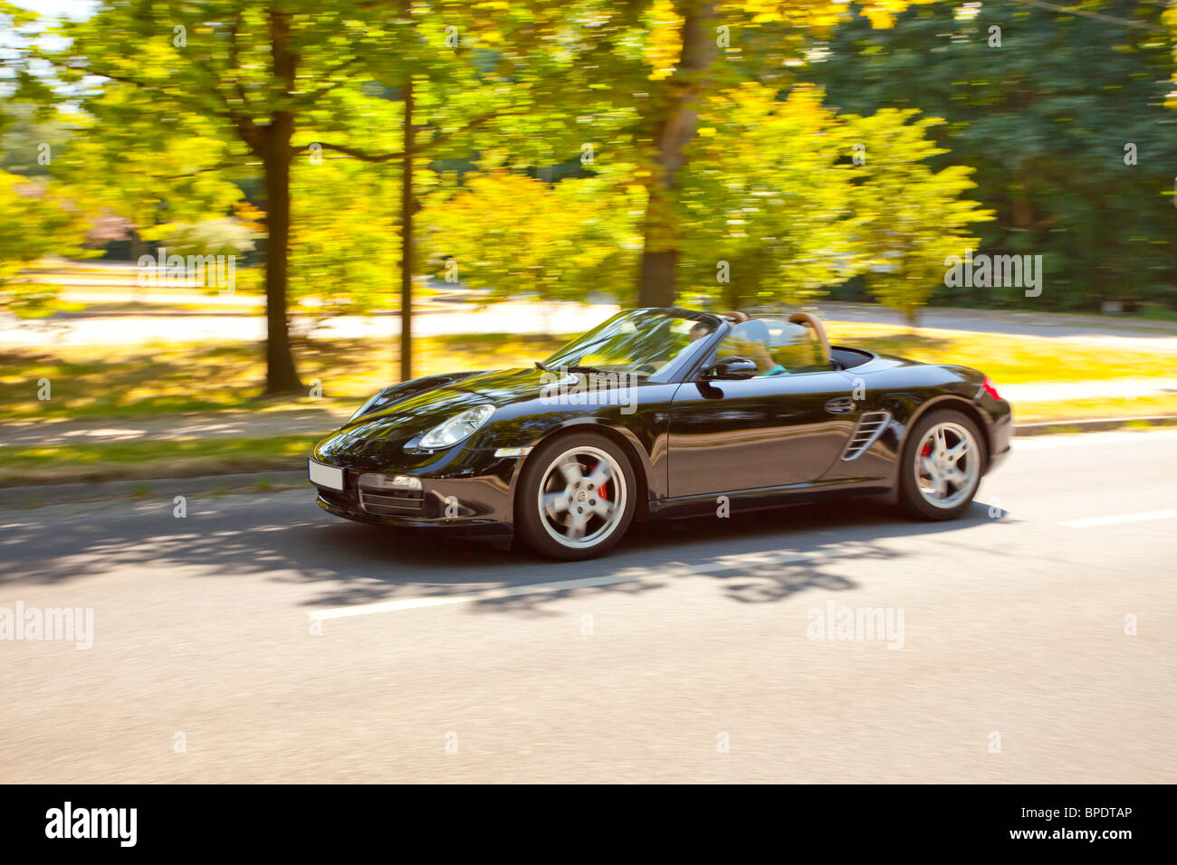 Sports car on country road,side view,blurred Stock Photo