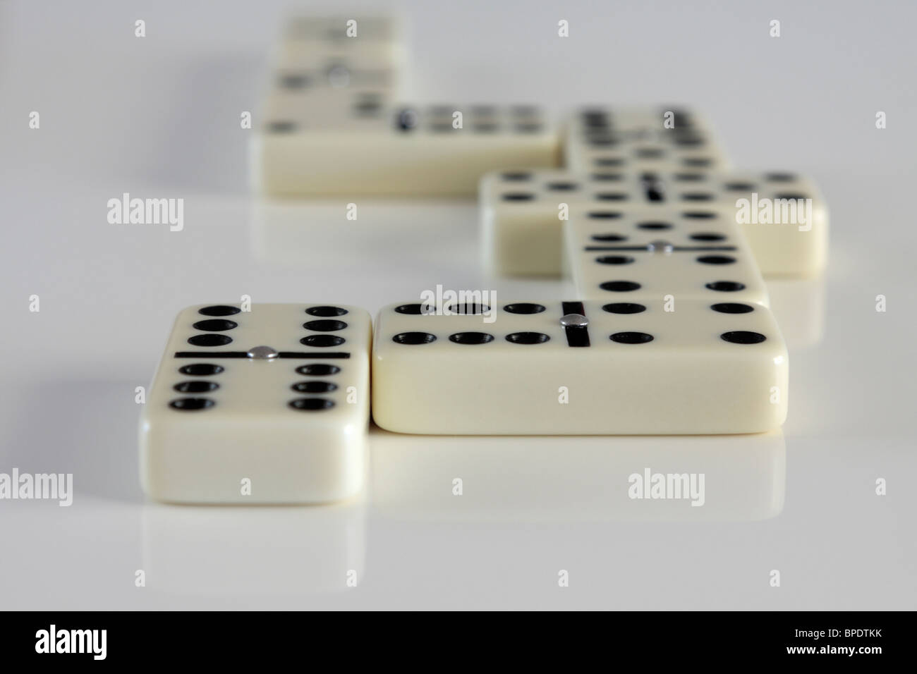 Dominoes lined up in a zig zag leading away counting down 6543210 and ...
