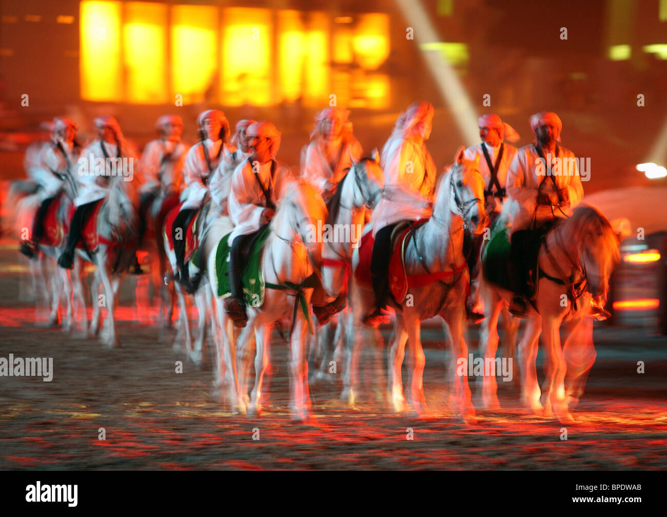 Riders in national clothing on thoroughbreds, Dubai, United Arab Emirates Stock Photo