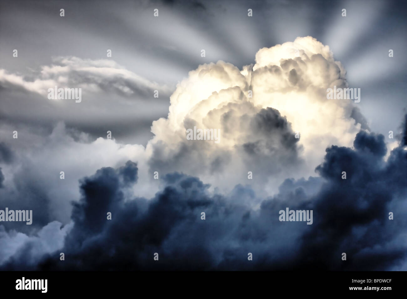 sun rays struggle through the storm clouds Stock Photo