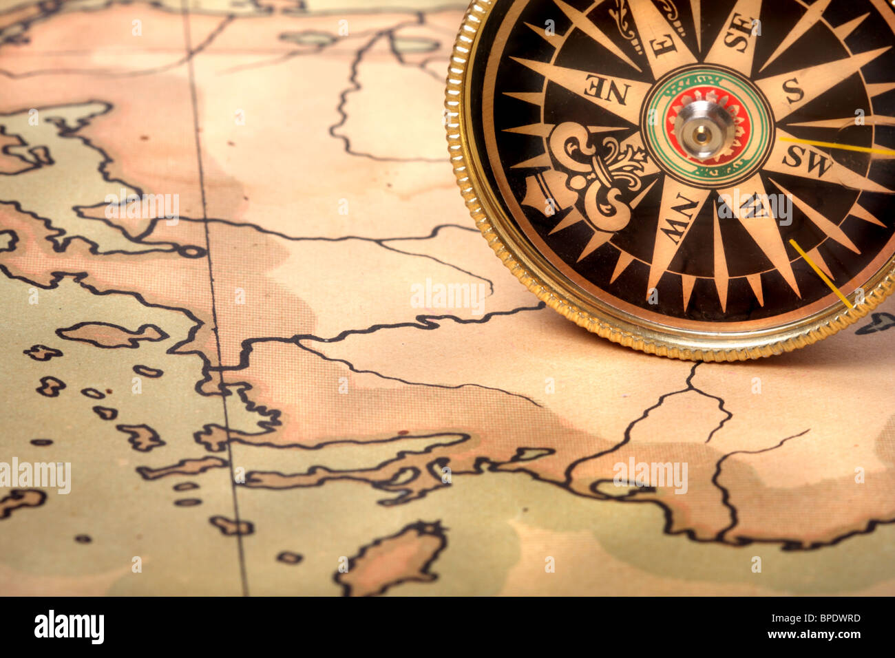 Compass on old contoured map, shallow DOF Stock Photo