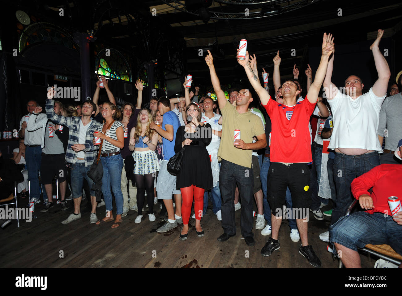 England football fans getting ready to cheer on the team during the 2010 world cap at the Concorde 2 a bar with a large screen Stock Photo
