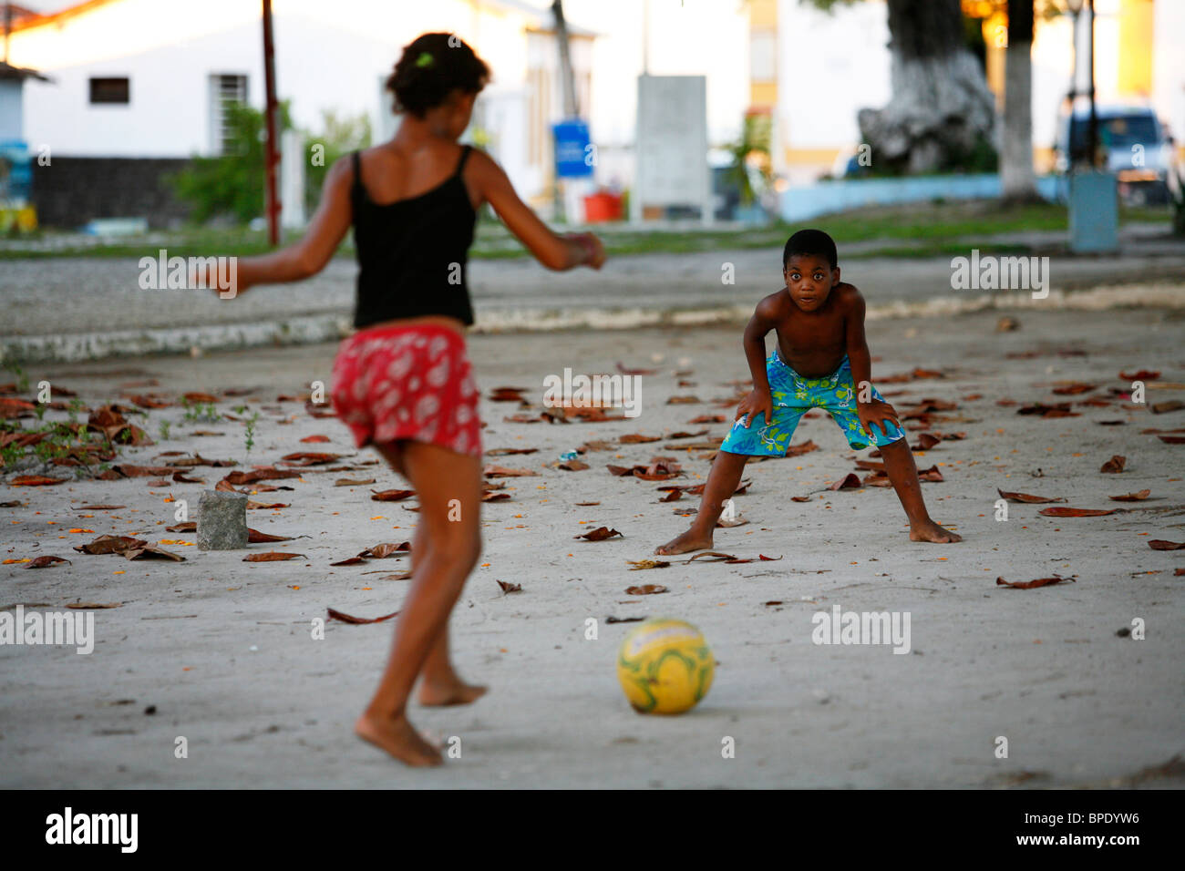 Kids playing football at Arraial d'Ajuda, Bahia, Brazil. Stock Photo