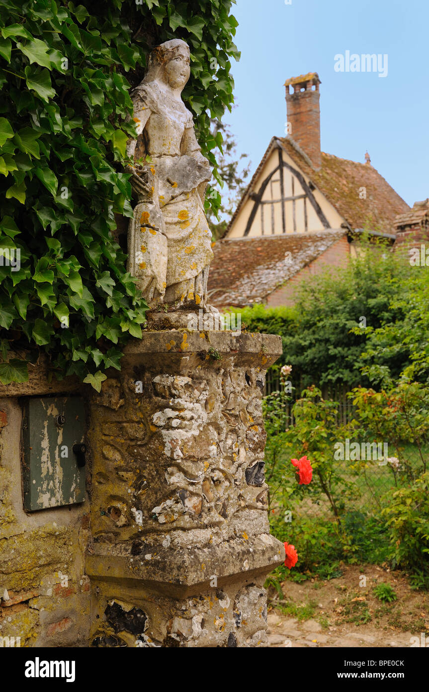 Weatherworn statue in the medieval French village of Gerberoy. Stock Photo