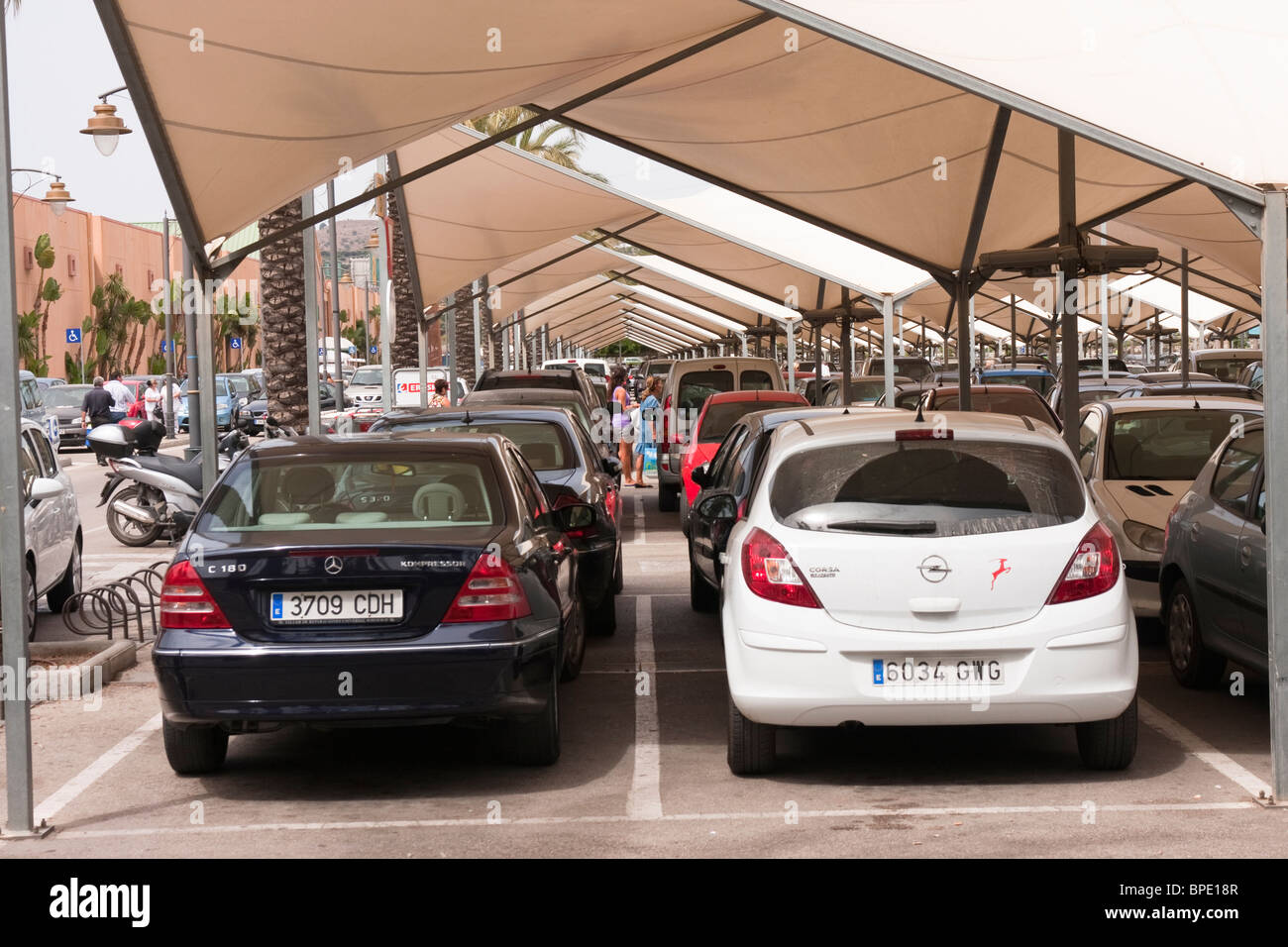 Covered car parking outside a Spanish supermarket to protect cars from