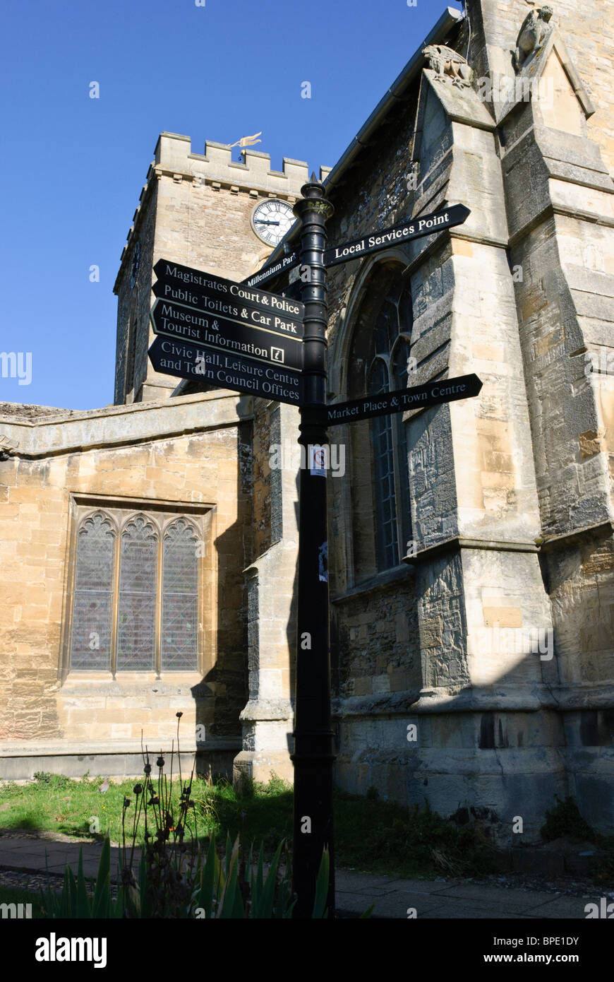 Sign giving directions in front of St. Peter and St. Paul's Church in the historic town of Wantage, Oxfordshire, England Stock Photo