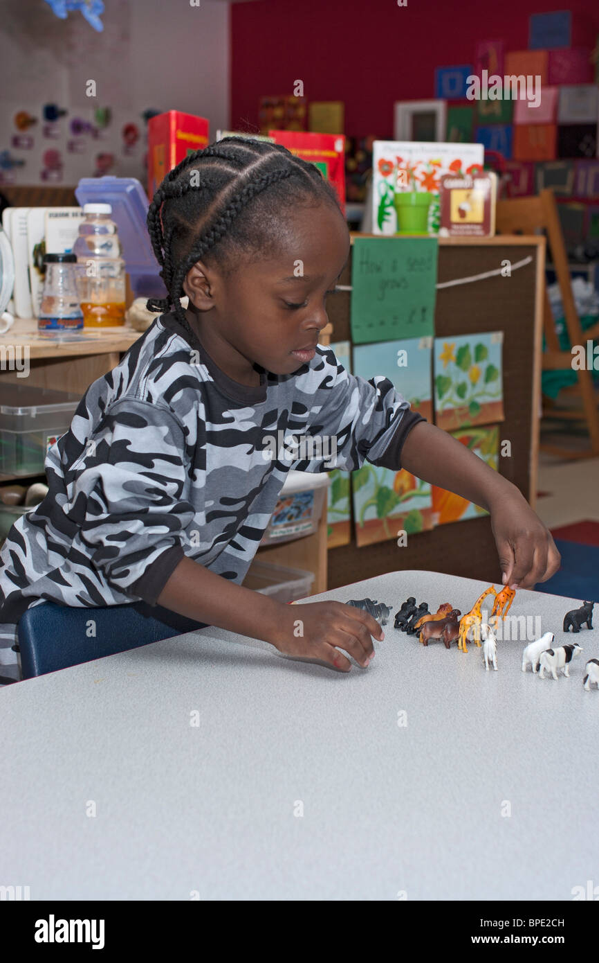 4 year old African-American preschool boy playing with toys in the classroom Stock Photo