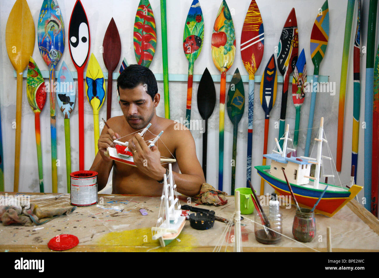Artist at a local workshop making wooden boats souvenirs, Parati, Rio de Janeiro State, Brazil. Stock Photo