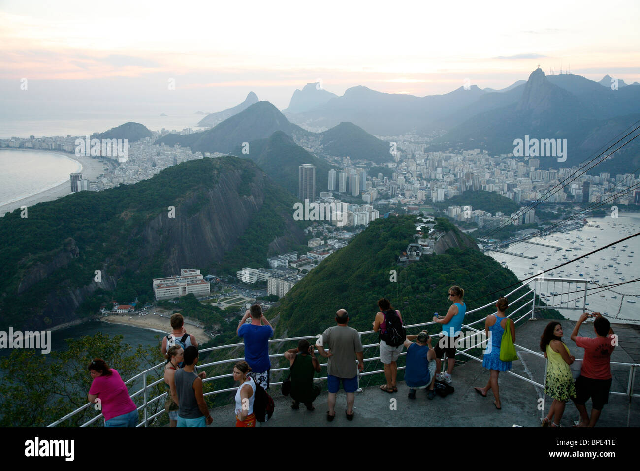 People on top of the Pao Asucar or Sugar loaf mountain with a view over the city, Rio de Janeiro, Brazil. Stock Photo