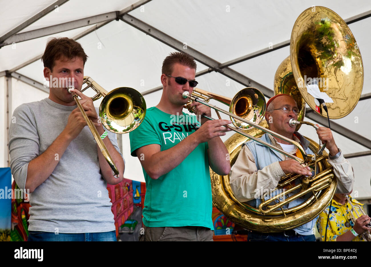 Musicians playing trombones and Sousaphone. Stroat Ensemble, a Dutch Big Band, performing at Edinburgh Mela 2010. Stock Photo