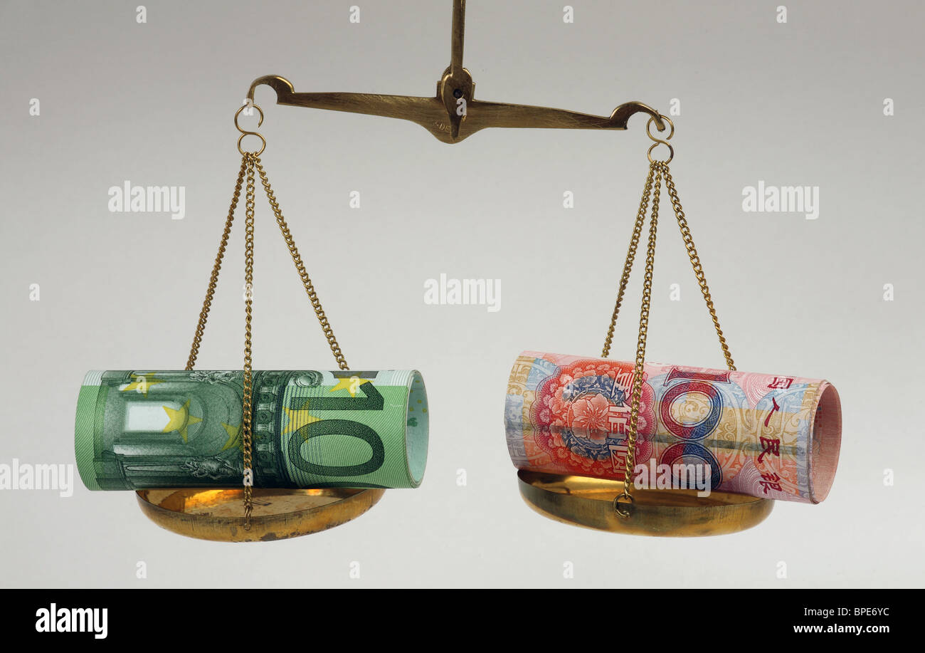 Euro and renminbi yuan banknotes on balanced scales Stock Photo