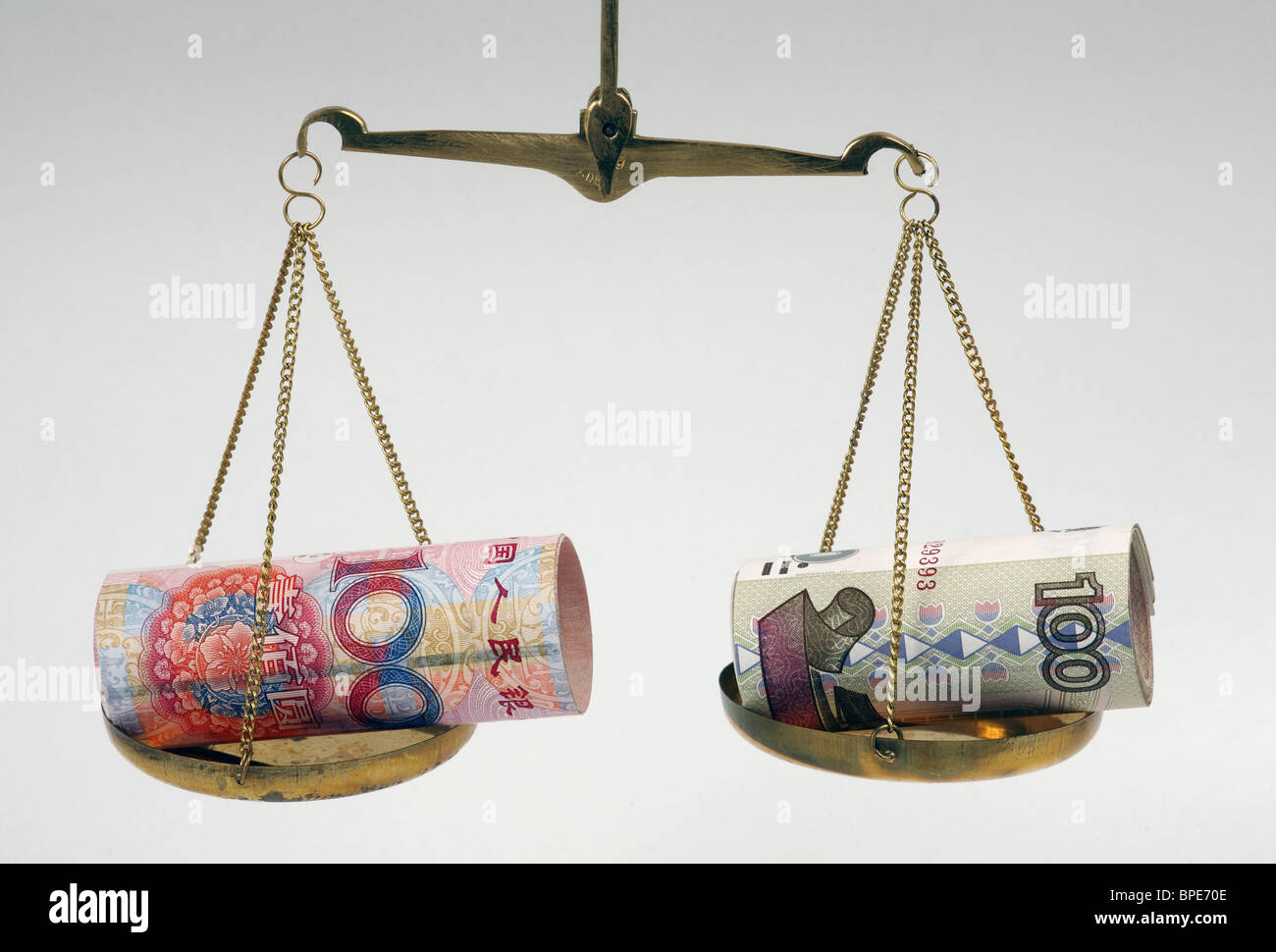 Ruble and renminbi yuan banknotes on balanced scales Stock Photo