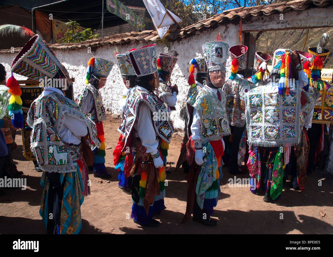A mens dancing group enters the arena to compete in the Virgin Carmel Festival, Pisac, Sacred Valley, Peru. Stock Photo