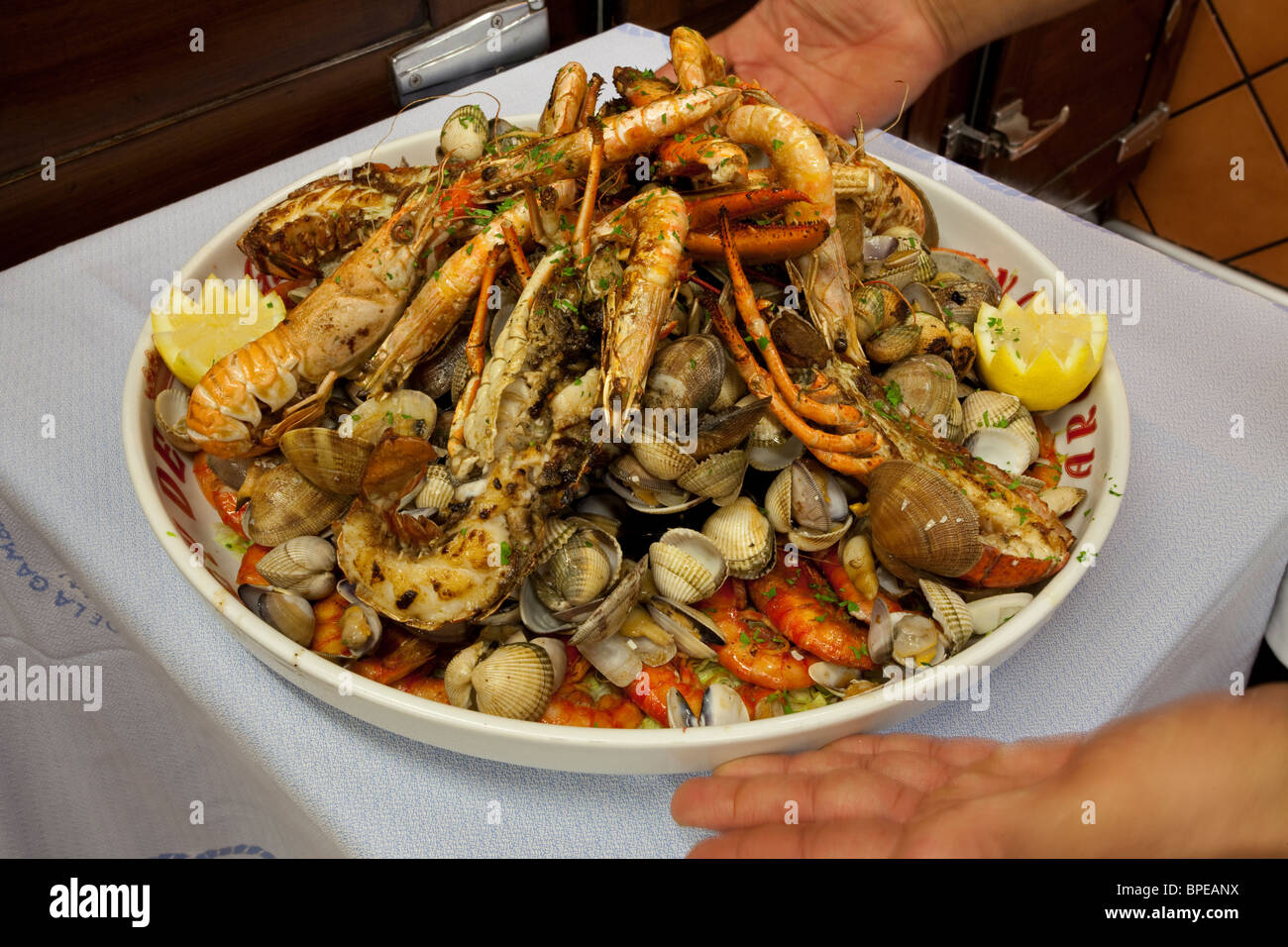 Barcelona displaying a dish of mariscada, Spain - Stock Image.