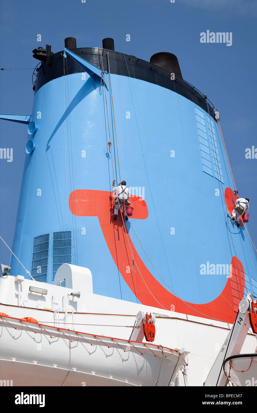 painting and maintenance on ship's funnel.Thomson cruise ship "Thomson Celebration". Corfu Stock