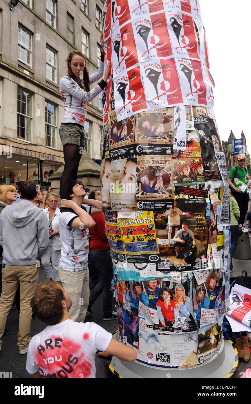 Putting up posters at the Edinburgh Fringe Arts Festival 2010 Stock