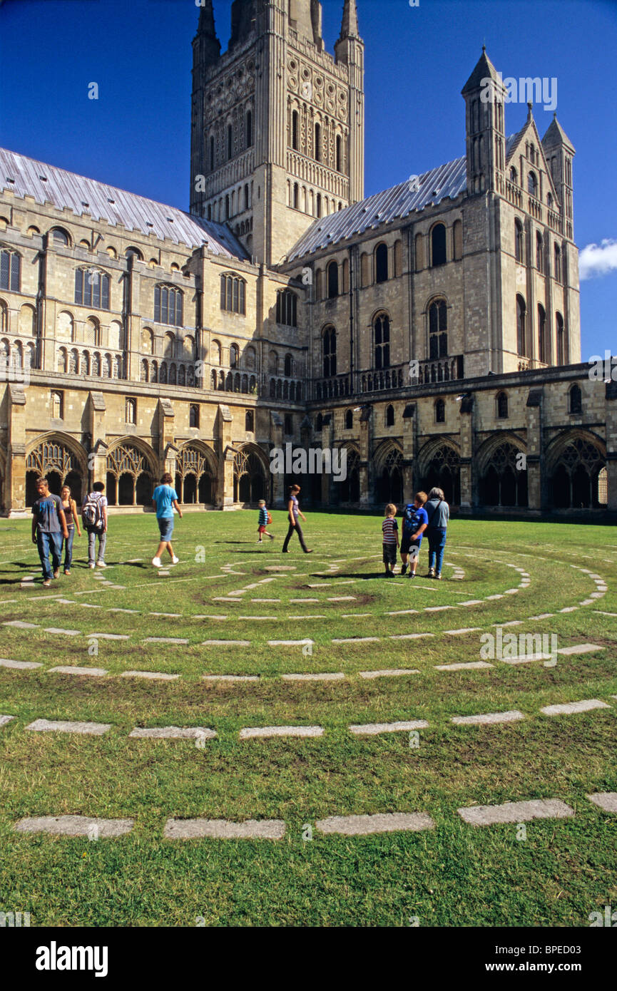 UK, England, Norfolk, Norwich Cathedral, Cloister lawn with people walking on labyrinth, cloister, crossing tower in center Stock Photo