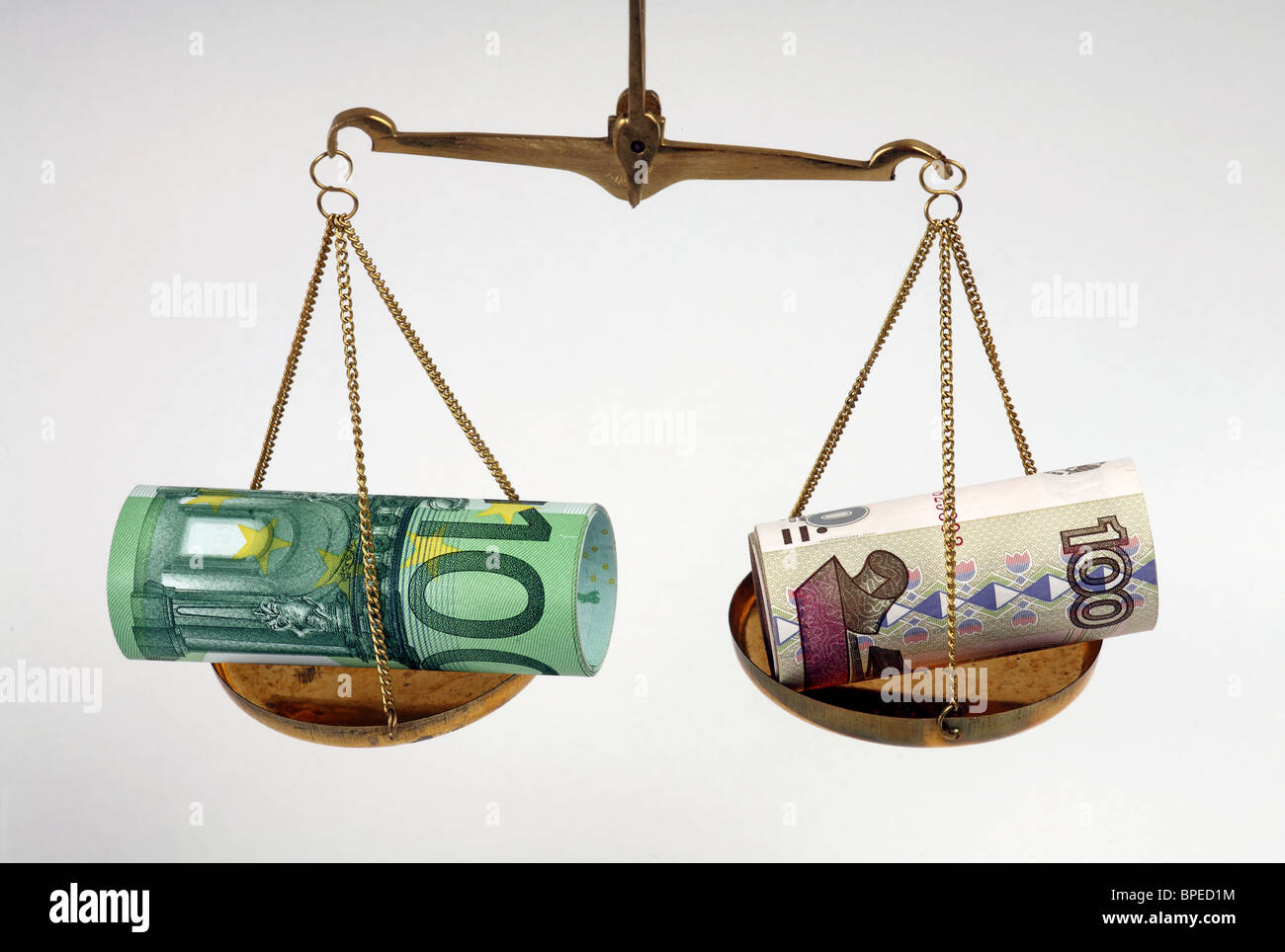Euro and ruble banknotes on balanced scales Stock Photo